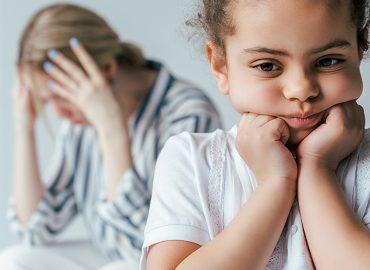 selective focus of sad african american kid touching face near divorced foster parents isolated on